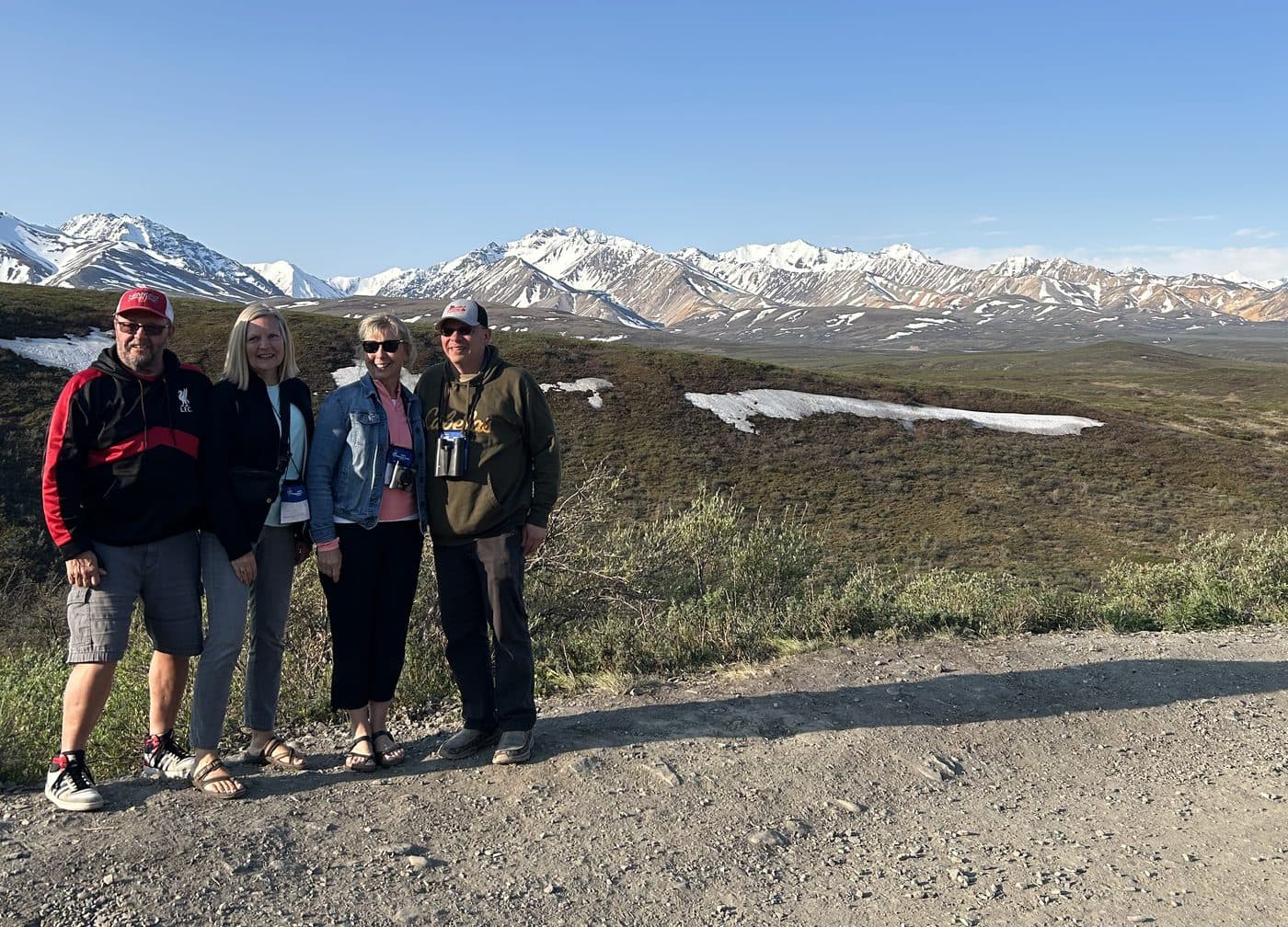 Travelers on tour with mountains behind them