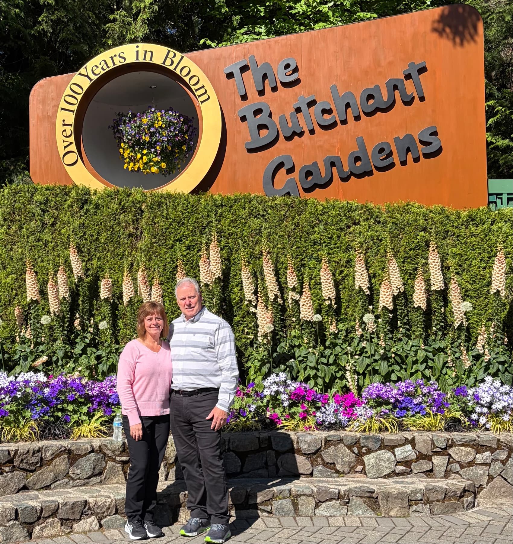 Amy and Randy in front of flowers and smiling