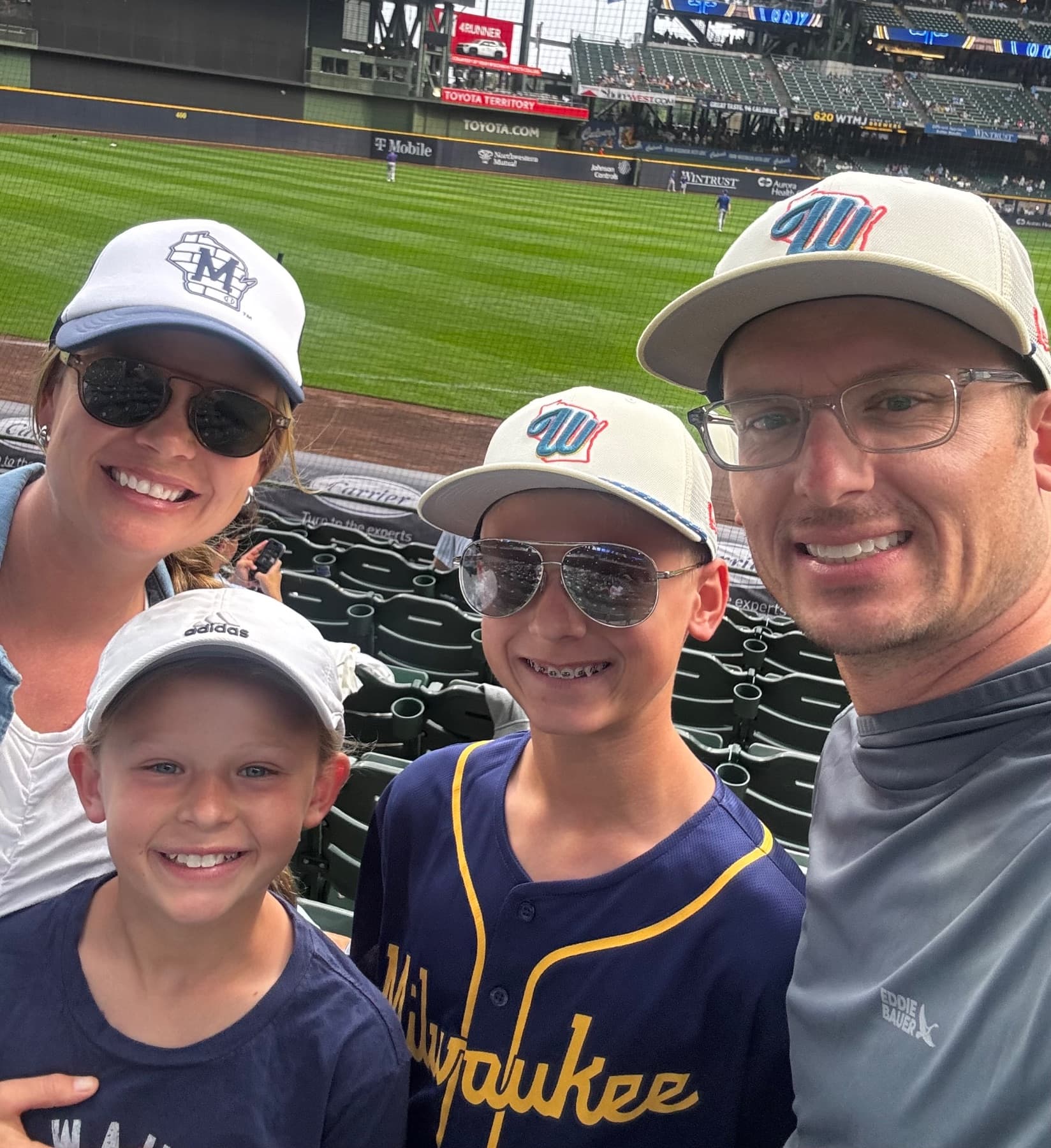 Tom and Becca Monroe with their family at a Brewers Game