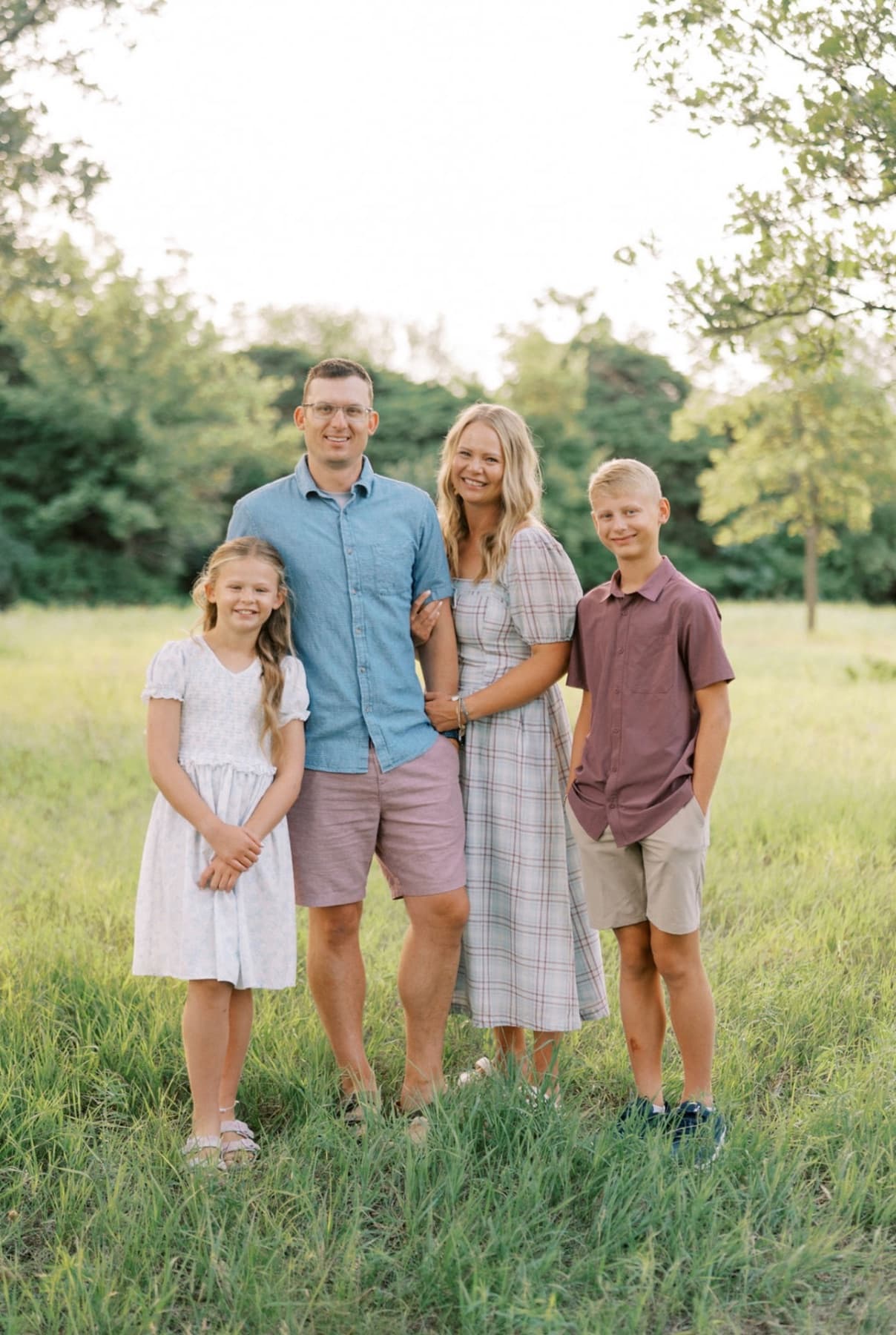 Tom and Becca - owners of TCT with their children in a nice green space setting.