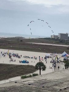 People on beach flying kites